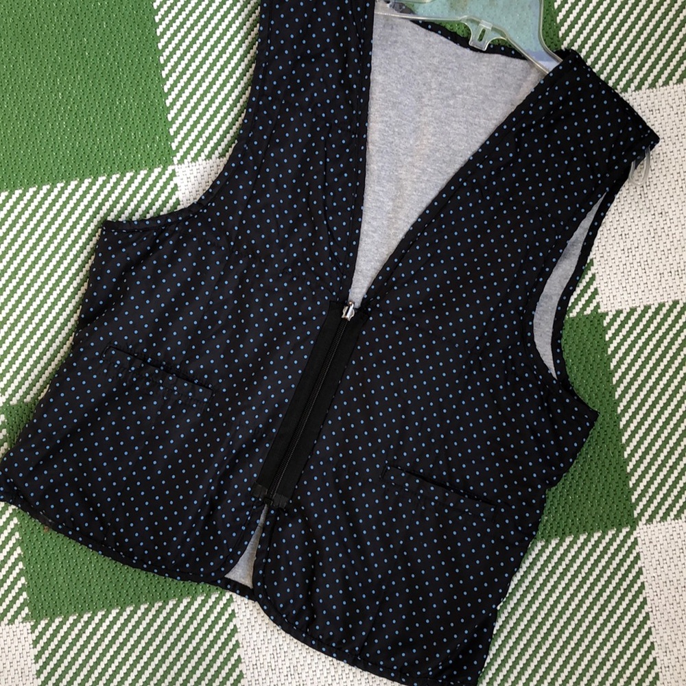 Reversible vest. Black w/blued dots or gray. Zipper close. new never worn.